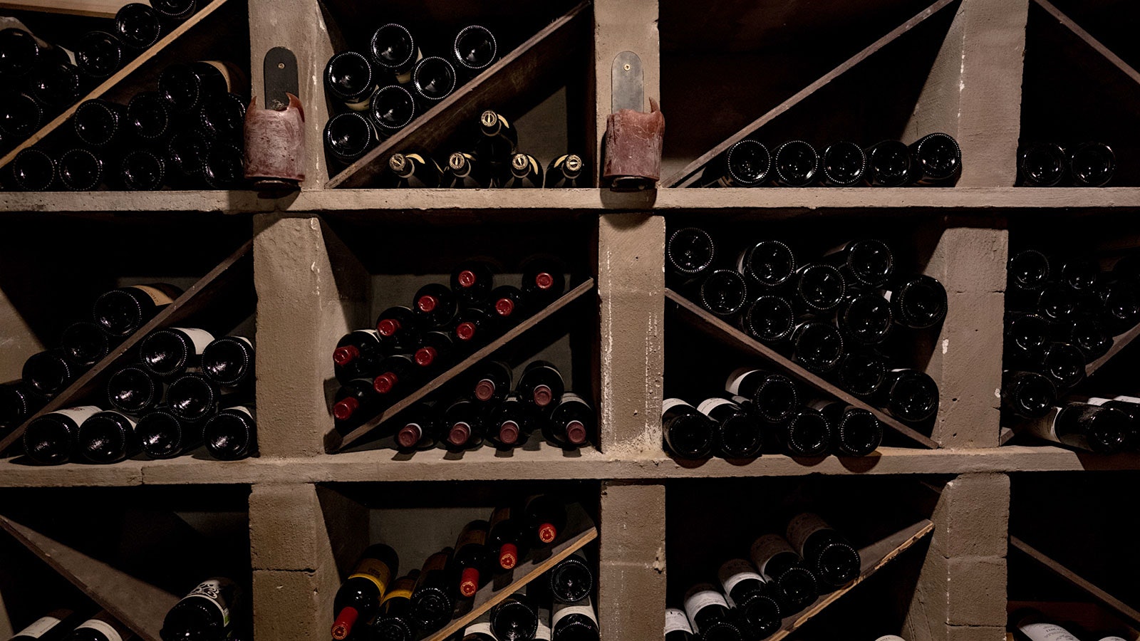 Classic and rare bottles of wine in an old wine cellar.